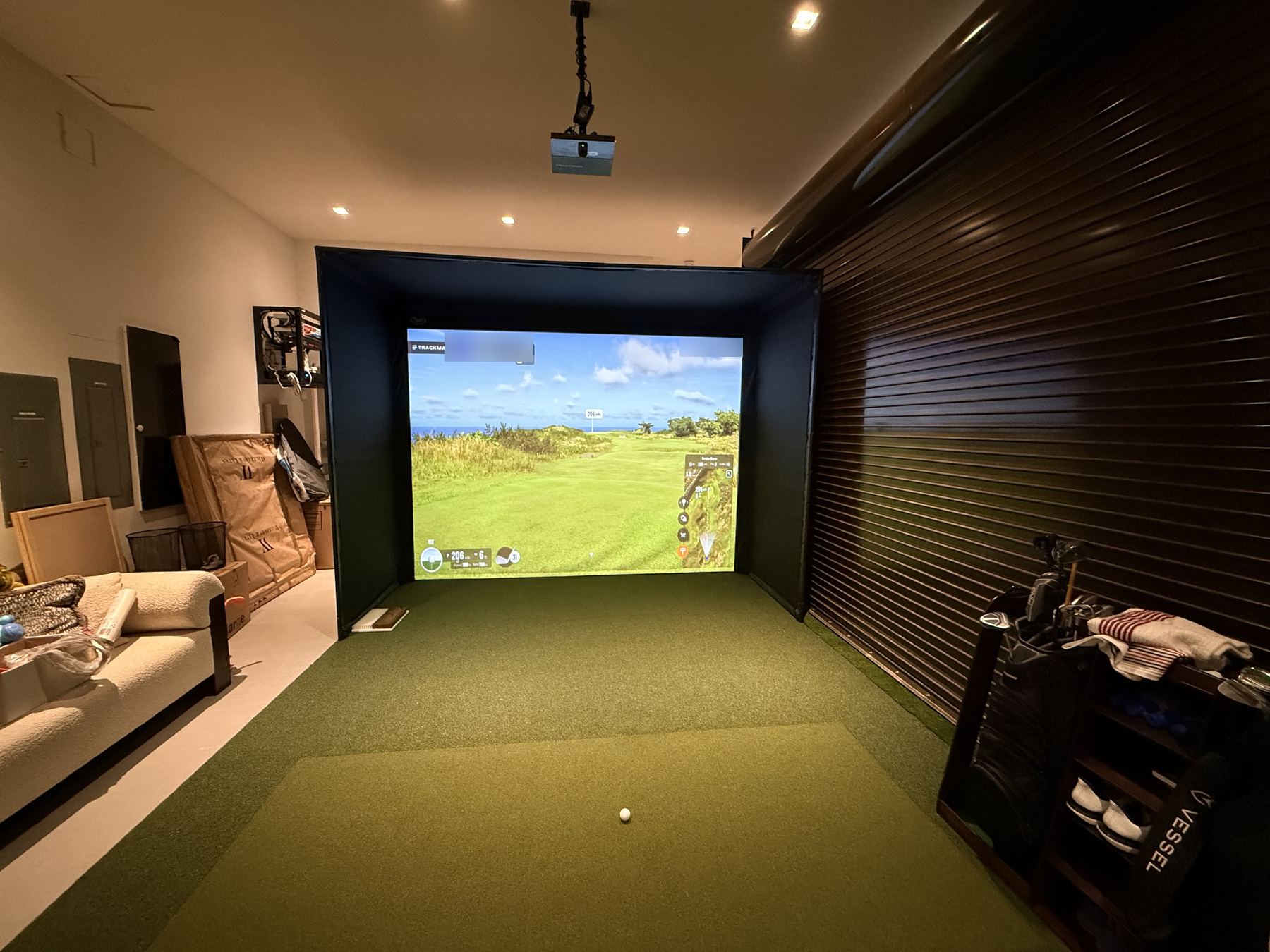 Modular enclosure in a garage beside a wood roll-up shutter.